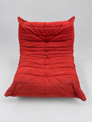 a red futon chair on a white background