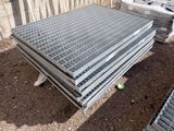 a pile of steel grates sitting on the ground
