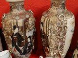 many vases and cups sitting on a red table
