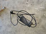 a cigarette and a charger on the concrete floor