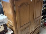 an image of a wooden armoire in a room