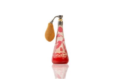 a bottle of perfume with a yellow handle on a white surface