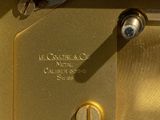 a close up of a gold clock with a key on it