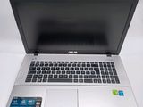 an open laptop computer sitting on top of a white table