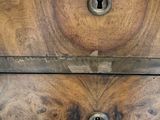 a close up of a wooden box with a keyhole on it