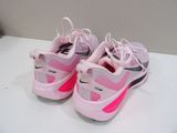 pink and black nike air max sneakers on a white surface