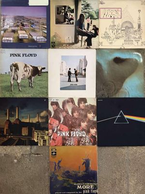 a lot of pink floyd posters on the wall