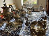 a blue and white table cloth with silver objects on it