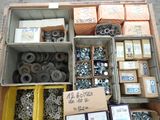 a box of assorted bolts and nuts on the ground