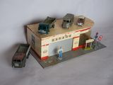 a toy garage with a car and a truck on it