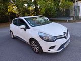a white car parked on the side of the road in front of a house