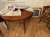 a table with a chair and a picture on the wall