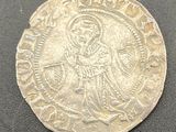 a silver coin with an image of jesus on it