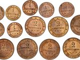 a close up of a bunch of coins on a white surface