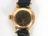an image of a close up of a wrist watch on a white surface