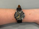 wrist shot of a person wearing a watch on their arm