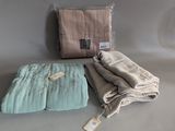 two blankets and a blanket on a table with a tag on it