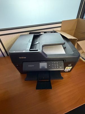 a printer that is sitting on a desk next to a box