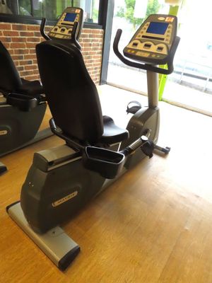 two stationary exercise bikes sitting on a wooden table