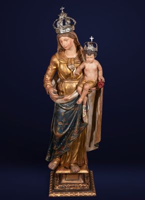 a statue of a woman holding a child wearing a crown