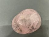 a pink quartz stone sitting on top of a table