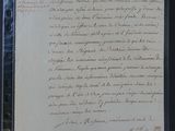 an old document with writing on it sitting on top of a table