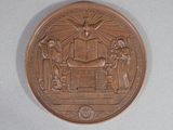 an image of a bronze medal with a picture of a man and a woman