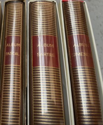 three books are in a box on a table
