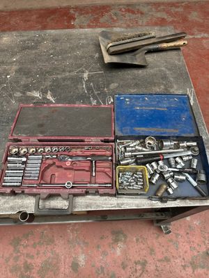 a tool box with tools on a table in a garage