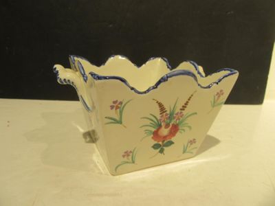 a small bowl with a flower design on it on a table