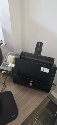 an image of a desk with a printer and a mouse