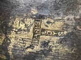 a close up of a cross on a piece of wood