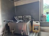 a picture of a kitchen with a sink and a coffee maker