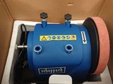 a blue machine that is in a box on the floor