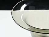 a black and white bowl sitting on a white table