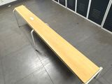 a bench in the middle of a room with lockers in the background