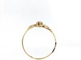 a close up of a gold ring with a diamond on it