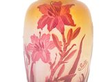 a glass vase with flowers on it on a white background