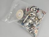 a bag full of assorted jewelry on a table