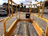 a yellow truck that is parked in a parking lot