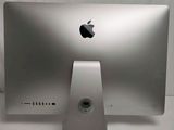 a silver apple desktop computer sitting on a white surface
