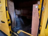 a yellow van with a door open in a garage