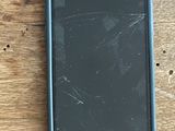 a close up of a cell phone sitting on a wooden table