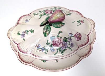 a white plate with a flower on it on a table
