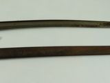 two old knives are sitting on a white surface next to each other
