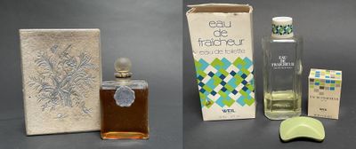 three bottles of perfume and a box of soap on a table