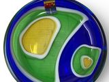 a blue and green plate with a fish design on it