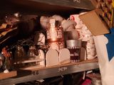 a lot of clutter on the shelves in the room