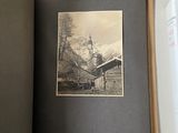 an open book with a picture of a mountain scene in it