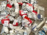 a pile of plastic bottles and other items on the ground